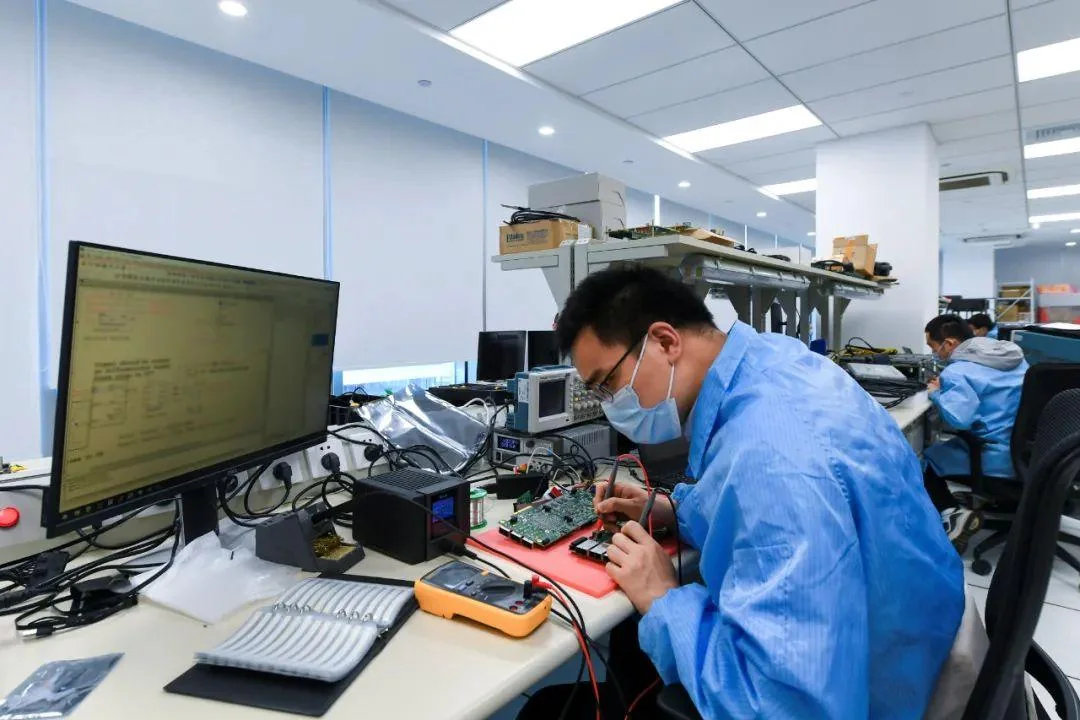 Engineer testing electronic circuit boards in a laboratory